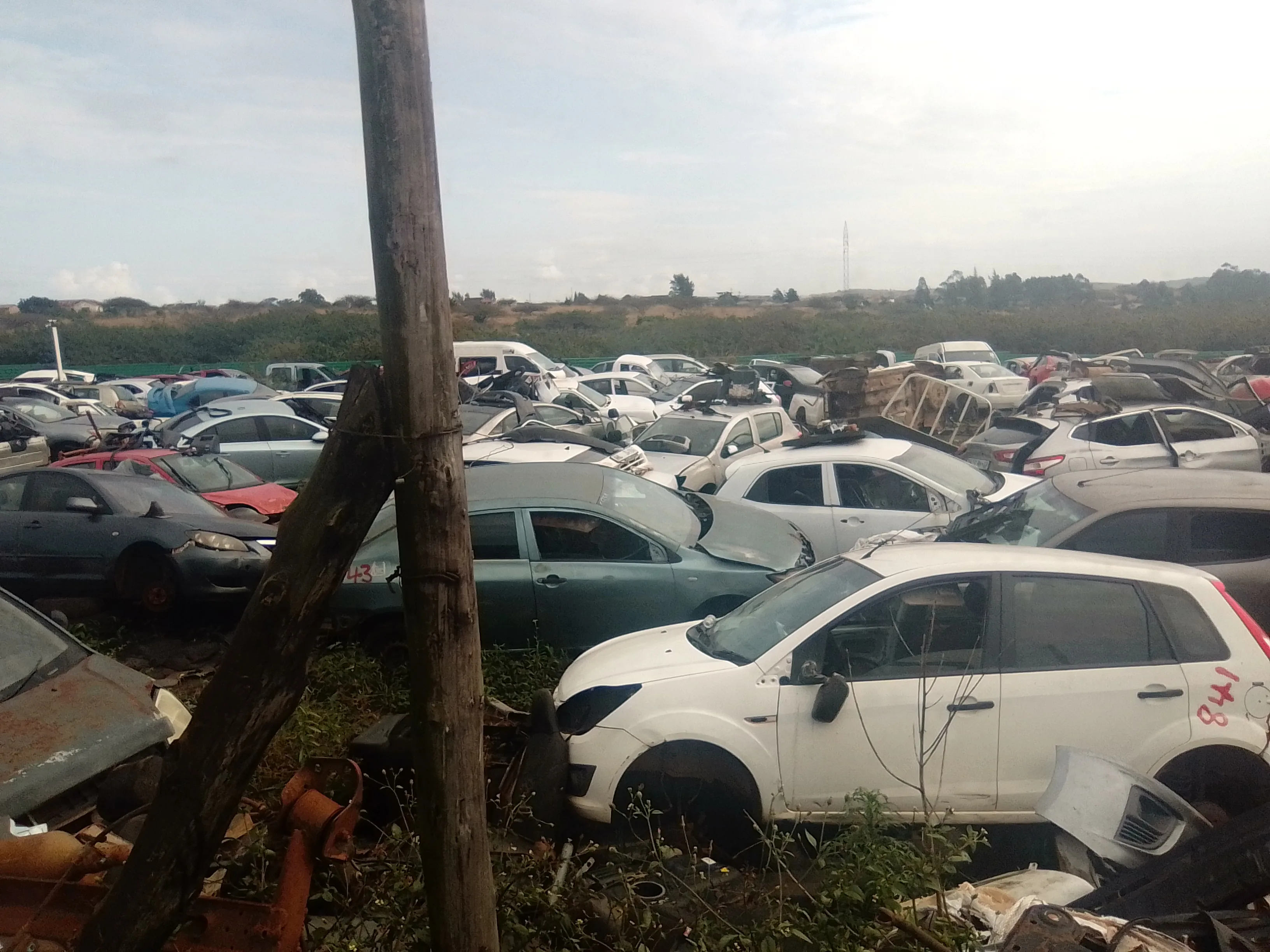 Maqimba Used Spares — vehicles stacked and stripped for parts
